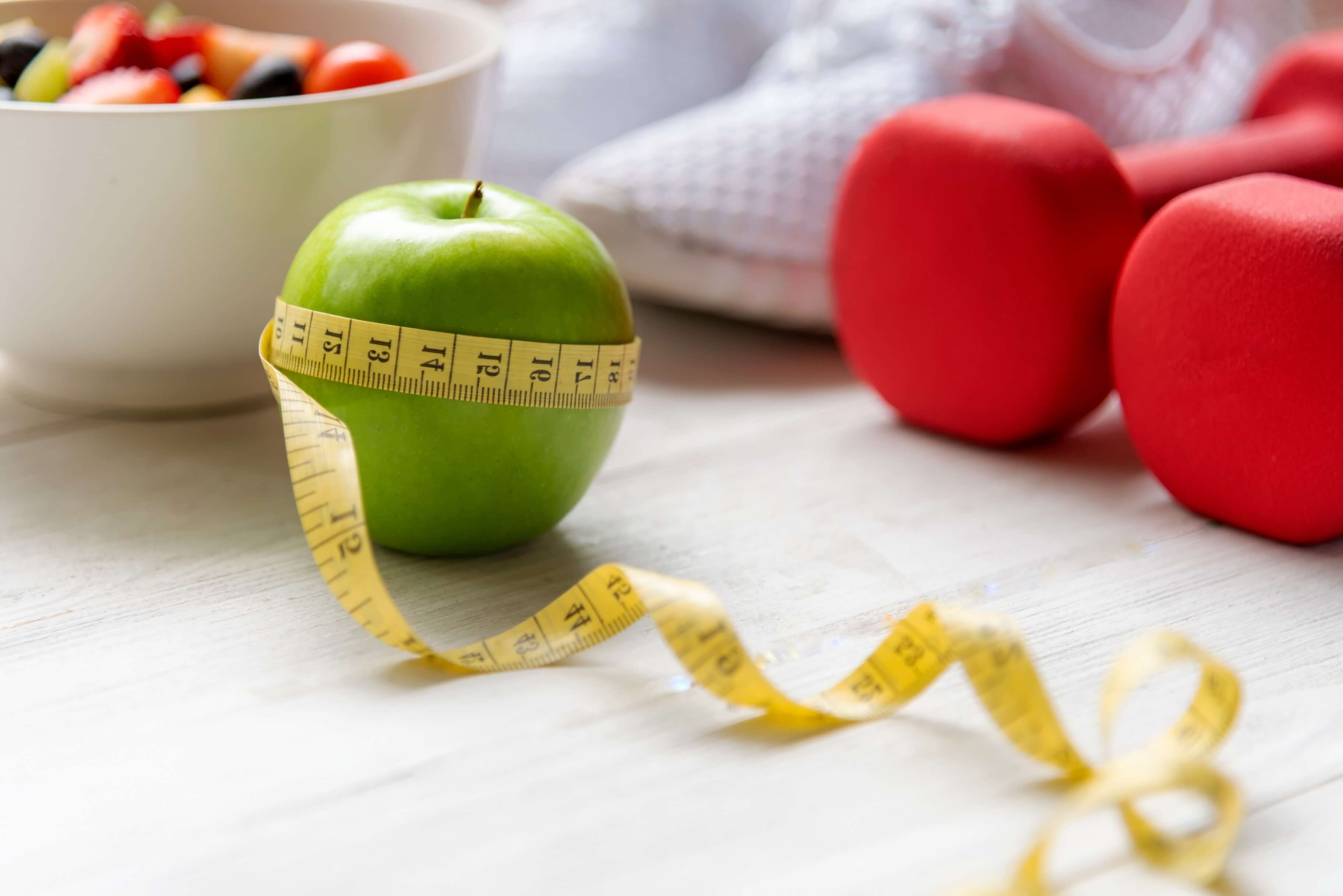 Abstract image of a measuring tape wrapped around an apple